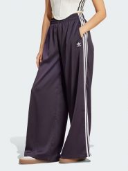 Adidas Spodnie dresowe w kolorze fioletowym rozmiar: 48. Różowe spodnie dresowe damskie Adidas, bez wzorów, z dresówki. Za 127.35 zł.