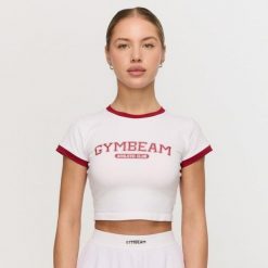 Koszulka damska fitness slim biała Varsity. Białe bluzki sportowe damskie GYMBEAM, l, bez wzorów, z elastanu, bez ramiączek. Za 88.90 zł.
