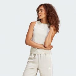 Koszulka Essentials Linear Slim Cotton Tank. Białe bluzki sportowe damskie Adidas, s, z bawełny, bez kołnierzyka, bez ramiączek. Za 89.95 zł.