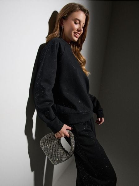 Bluza crewneck z połyskującymi aplikacjami - czarny. Czarne bluzy bez kaptura damskie Sinsay, l. Za 49.99 zł.
