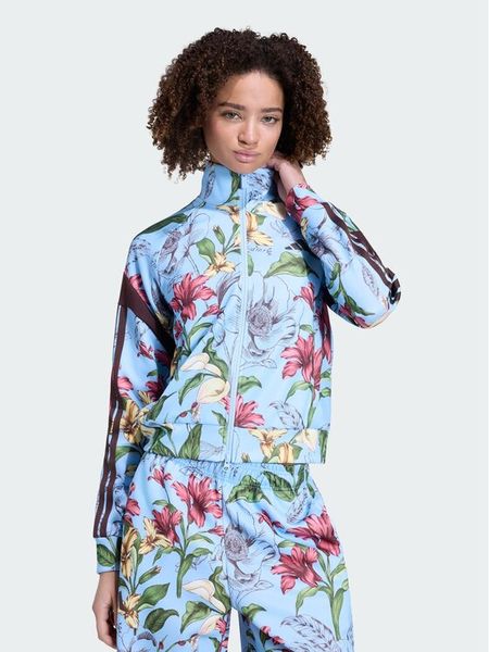 Adidas Bluza X Frarm Rio House Of Trio Track Top KX0043 Niebieski jasny Regular Fit. Niebieskie bluzy bez kaptura damskie Adidas, s, bez wzorów, z syntetyku, bez ramiączek. Za 348.99 zł.