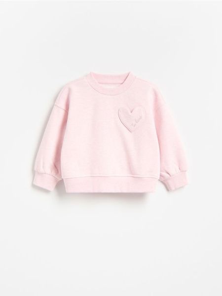 Luźna bluza - pastelowy róż. Czerwone bluzy i bluzki niemowlęce Reserved, bez wzorów, z bawełny, bez ramiączek, bez kaptura. Za 45.99 zł.
