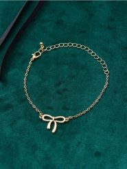 Bransoletka z zawieszką w kształcie kokardy - złoty. Żółte bransoletki damskie Sinsay, złote. Za 12.99 zł.