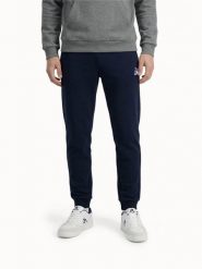 Spodnie Tricolores - Decathlon - Premium z trójkolorowym akcentem. Niebieskie spodnie materiałowe męskie Le Coq Sportif, bez wzorów, z bawełny, klasyczne. Za 445.00 zł.