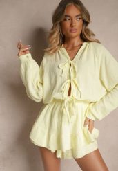 Żółty Kombinezon z Bawełny Ozdobiony Wiązaniem i Falbankami Nalelia. Żółte kombinezony damskie Renee, bez wzorów, z bawełny, eleganckie, bez kołnierzyka, bez ramiączek. Za 139.99 zł.