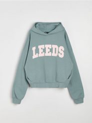 Bluza hoodie oversize z napisem - turkusowy. Niebieskie bluzy bez kaptura damskie Sinsay, l, bez wzorów, bez ramiączek, bez kaptura. Za 49.99 zł.