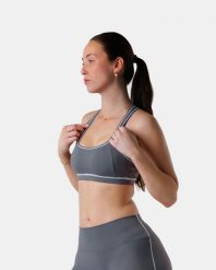 Damski stanik sportowy racerback z kontrastową lamówką na siłownię – szary. Szare biustonosze sportowe damskie AESTHETIC WOLF, bez wzorów, z dzianiny. Za 179.99 zł.