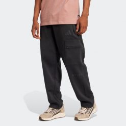 Spodnie męskie ADIDAS. Czarne spodnie materiałowe męskie Adidas, bez wzorów, z bawełny. W wyprzedaży za 199.99 zł.