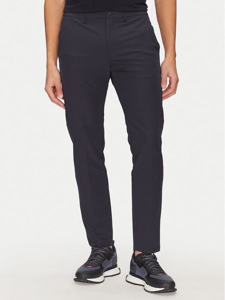 BOSS Spodnie materiałowe T_Commuter 50534303 Granatowy Slim Fit. Niebieskie spodnie materiałowe męskie Boss, bez wzorów, z materiału. Za 359.99 zł.