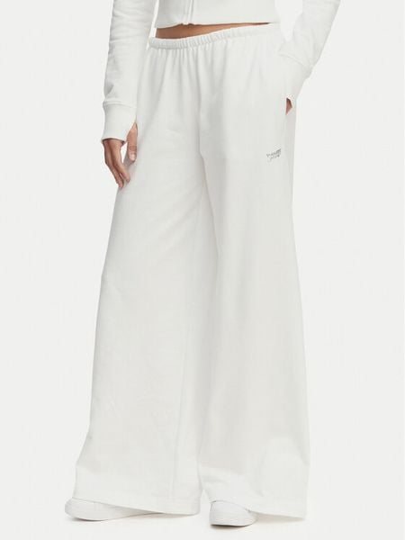 Tommy Jeans Spodnie dresowe Metallic Logo DW0DW22735 Biały Wide Leg. Białe jeansy damskie Tommy Jeans, xxs, bez wzorów, z bawełny. Za 409.99 zł.