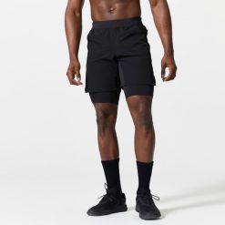 Spodenki fitness cardio męskie Domyos 2 w 1. Czarne szorty sportowe męskie DOMYOS, m, z elastanu, na fitness i siłownię. Za 89.99 zł.