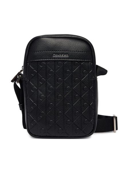 Calvin Klein Saszetka Emblem Aop Emboss Slim Reporter LV04D3228G Czarny. Czarne saszetki męskie CALVIN KLEIN, ze skóry. Za 329.99 zł.