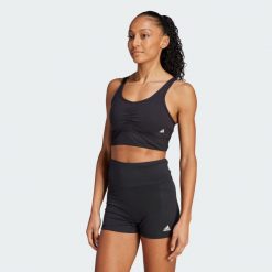 Biustonosz Essentials Medium-Support. Czarne biustonosze sportowe damskie Adidas, bez wzorów, z materiału. W wyprzedaży za 147.50 zł.