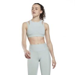 Biustonosz dla kobiet Reebok Studio. Niebieskie biustonosze sportowe damskie Reebok, bez wzorów, z dzianiny. Za 184.45 zł.