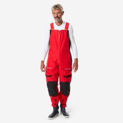 Spodnie żeglarskie męskie Decathlon 500 na szelkach. Czerwone spodnie materiałowe męskie Decathlon, bez wzorów, z polaru, sportowe. Za 489.99 zł.