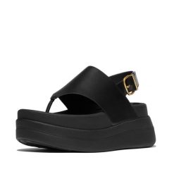 Kobiece sandały na koturnie ze skórzaną tylną paskiem FitFlop F-Mode. Czarne sandały damskie FIT FLOP, bez wzorów, z materiału, bez obcasa, na koturnie. Za 610.50 zł.