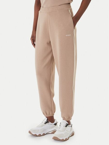 Guess Spodnie dresowe V6GB02 K2915 Beżowy Regular Fit. Brązowe spodnie dresowe damskie Guess, xl, z aplikacjami, z dresówki. Za 335.99 zł.