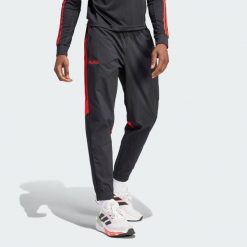 Spodnie Predator 30th Anniversary Woven. Czarne spodnie materiałowe męskie Adidas, bez wzorów, z materiału, sportowe. W wyprzedaży za 242.95 zł.