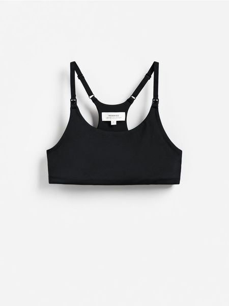 Sportowy top - czarny. Czarne topy sportowe damskie Reserved, l, bez wzorów, z dzianiny, bez ramiączek. Za 79.99 zł.