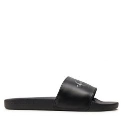 Klapki Calvin Klein Jeans. Czarne klapki damskie Calvin Klein Jeans, bez wzorów, z jeansu, bez obcasa. Za 469.99 zł.