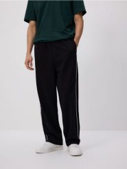 Spodnie loose fit - granatowy. Niebieskie spodnie materiałowe męskie Reserved, bez wzorów, z bawełny. Za 119.99 zł.