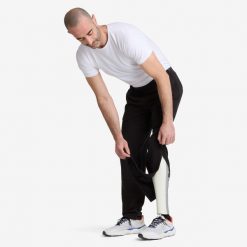 Spodnie męskie rozpinane Decathlon. Czarne spodnie materiałowe męskie Decathlon, bez wzorów, z bawełny, sportowe. Za 129.99 zł.