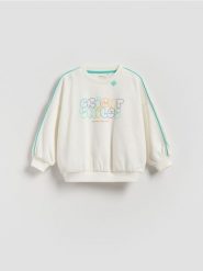 Bawełniana bluza - złamana biel. Bluzy i bluzki niemowlęce Reserved, bez wzorów, z bawełny, bez ramiączek, bez kaptura. Za 49.99 zł.