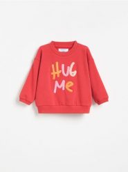 Bluza z aplikacją - czerwony. Czerwone bluzy i bluzki niemowlęce Reserved, z aplikacjami, z bawełny, bez ramiączek, bez kaptura. Za 49.99 zł.