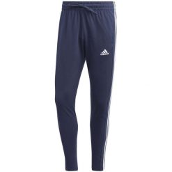 Spodnie męskie adidas Essentials Single Jersey Tapered Open Hem 3-Stripes. Czarne spodnie materiałowe męskie Adidas, bez wzorów, z jersey. Za 159.00 zł.
