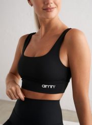 Damski biustonosz sportowy średnie wsparcie, wyjmowane wkładki Core czarny. Czarne biustonosze sportowe damskie Aim'n, bez wzorów, z elastanu. Za 212.00 zł.