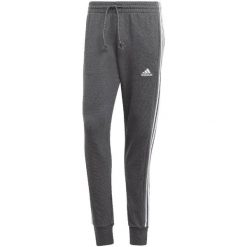 Spodnie męskie adidas Essentials French Terry Tapered Cuff 3-Stripes. Białe spodnie materiałowe męskie Adidas, bez wzorów, sportowe. Za 182.00 zł.