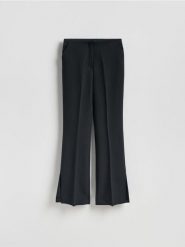 Spodnie z rozcięciami long leg - czarny. Czarne spodnie materiałowe damskie Reserved, bez wzorów, z tkaniny. Za 129.99 zł.