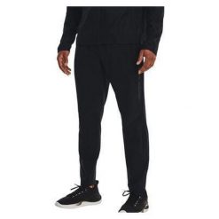 Spodnie do biegania męskie Under Armour Storm Run. Czarne spodnie materiałowe męskie Under Armour, bez wzorów, sportowe. Za 177.99 zł.