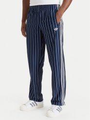 Adidas Spodnie dresowe Firebird Pinstripes Track Pants KR7231 Granatowy Regular Fit. Niebieskie spodnie dresowe męskie Adidas, bez wzorów, z dresówki. Za 349.99 zł.