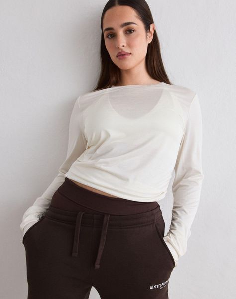 Damski top treningowy prześwitujący, elastyczny, drapowany Luminous ecru. Białe topy sportowe damskie Aim'n, s, z aplikacjami, z elastanu, bez ramiączek. Za 254.00 zł.