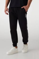 GUESS Czarne męskie spodnie dresowe z lampasami Mickey. Czarne spodnie dresowe męskie Guess, z aplikacjami, z bawełny. W wyprzedaży za 332.99 zł.