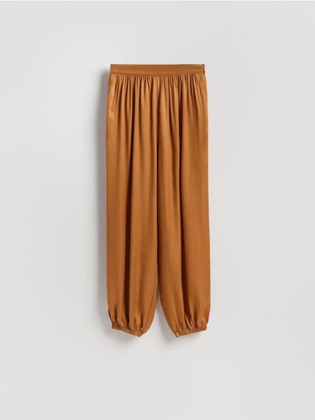 Spodnie joggery - brązowy. Brązowe spodnie materiałowe damskie Reserved, bez wzorów, z tkaniny. Za 199.99 zł.