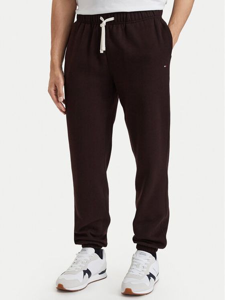 Tommy Hilfiger Spodnie dresowe Essential MW0MW37231 Brązowy ciemny Relaxed Fit. Brązowe spodnie dresowe męskie Tommy Hilfiger, bez wzorów, z dresówki. Za 449.99 zł.