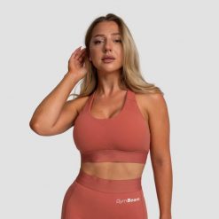Biustonosz sportowy damski fitness regulowany cynamonowy Limitless. Brązowe biustonosze sportowe damskie GYMBEAM, bez wzorów, z elastanu. Za 85.90 zł.
