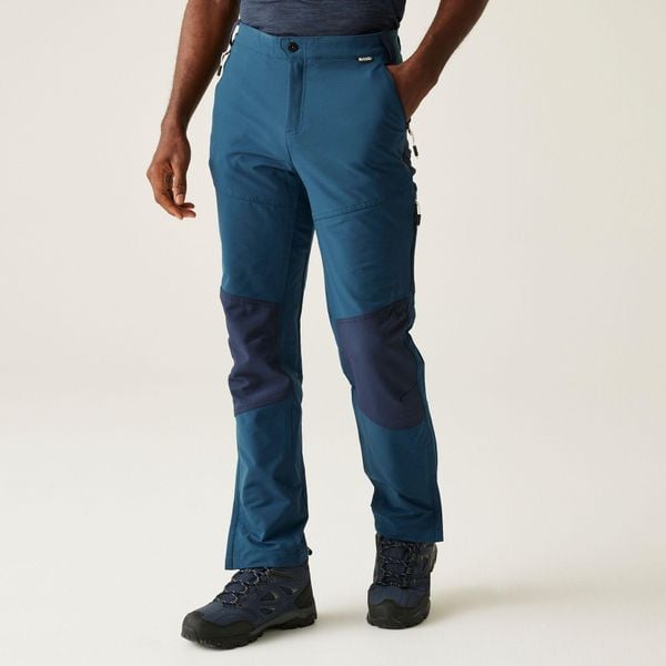 Questra V Męskie spacerowe spodnie turystyczne. Niebieskie spodnie materiałowe męskie Regatta, bez wzorów, sportowe. W wyprzedaży za 256.50 zł.